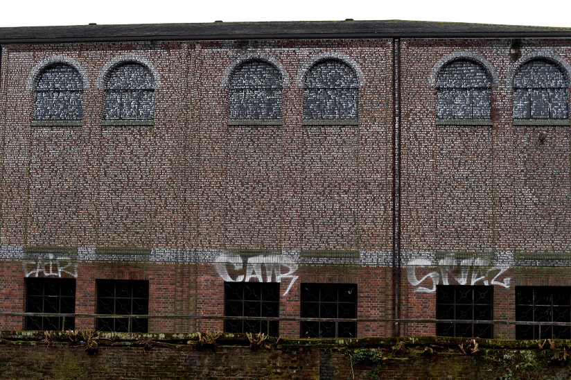 Photo of the novel Utopia (Sir Thomas More) written in paint on an old building in Norwich, England