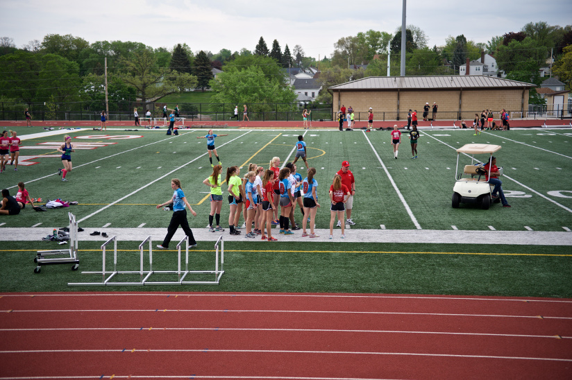 Photo of a track and field high school team and their coach