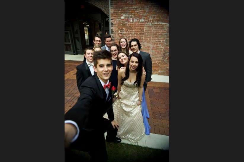 Photo of a group of friends who are taking a selfie before the prom