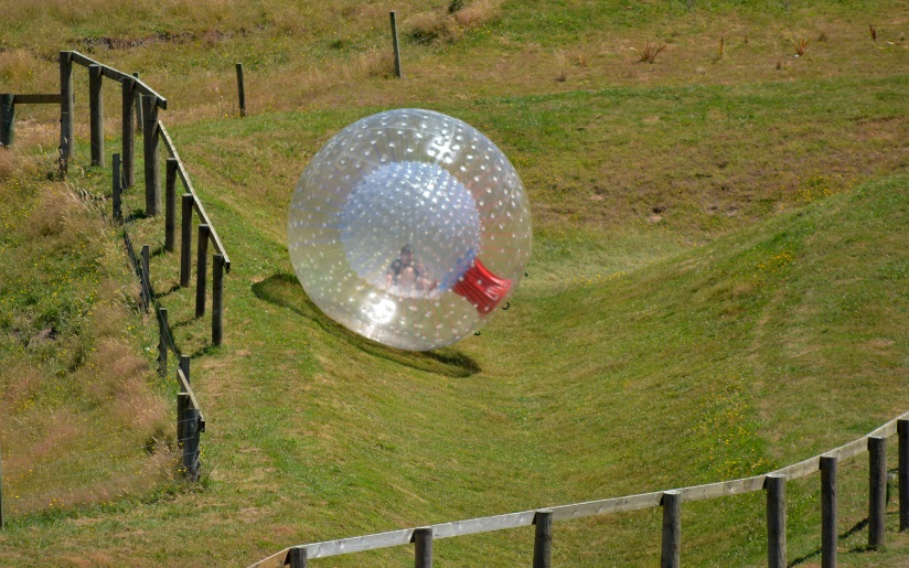 Photo of a dry zorb rolling down a track