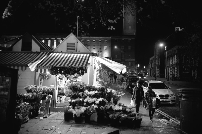 Photo of a flower shop and a couple in the evening