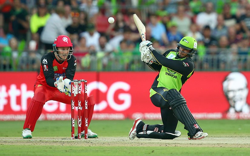 Photo of two men playing cricket