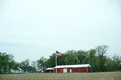 Photo of an American farm and an American flag