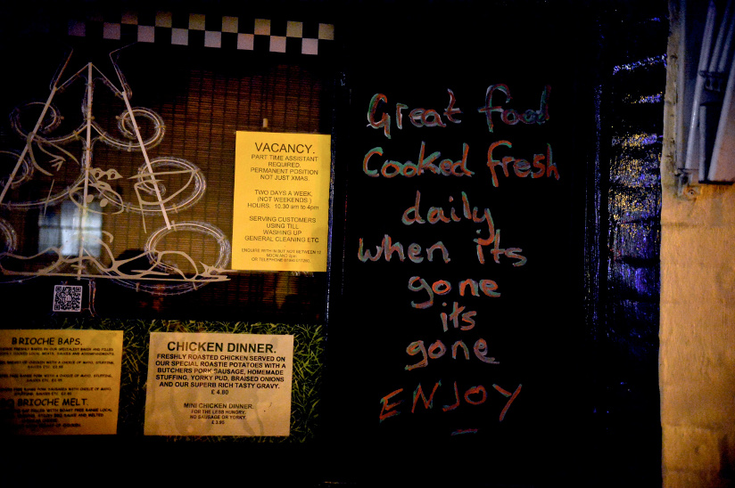 Photo of an advertisement for food and vacant positions at a café