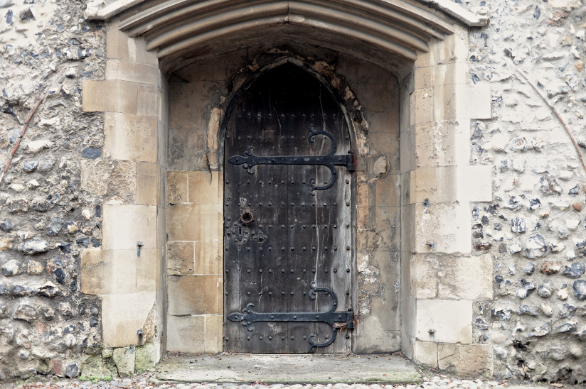 Photo of an old brick building and a door