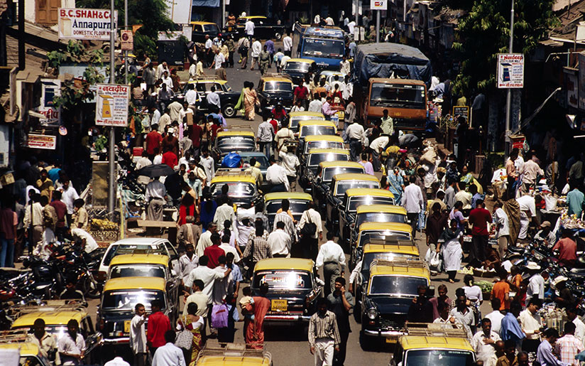 Photo of a crowded street with people and cars in Mumbai